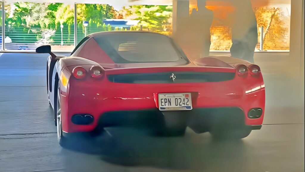 Ferrari Enzo smoking in a parking lot draws onlookers' frantic warnings official exterior hero view