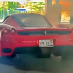 Ferrari Enzo smoking in a parking lot draws onlookers' frantic warnings official exterior hero view